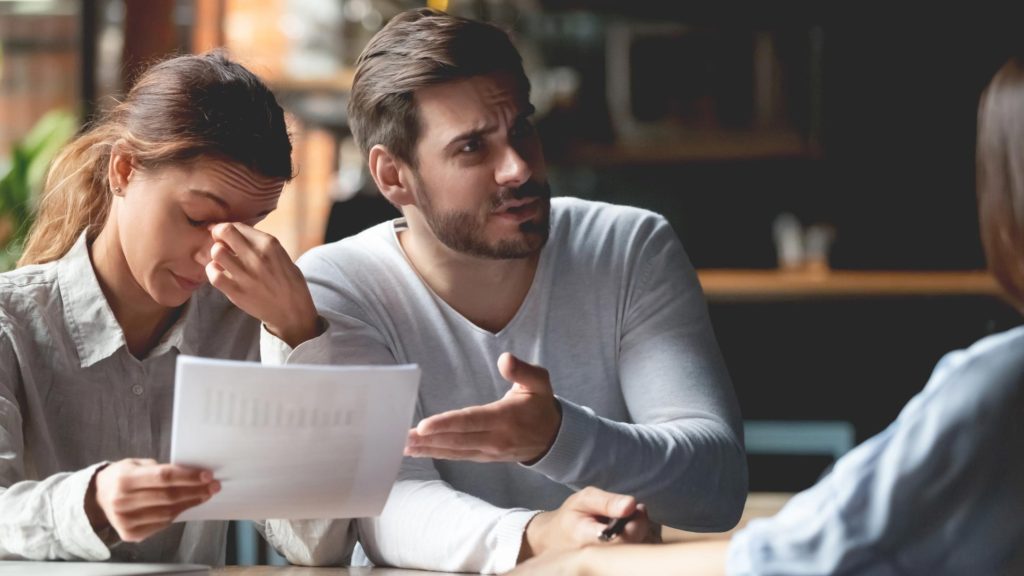 Photo of a young male and female frustrated with their manager